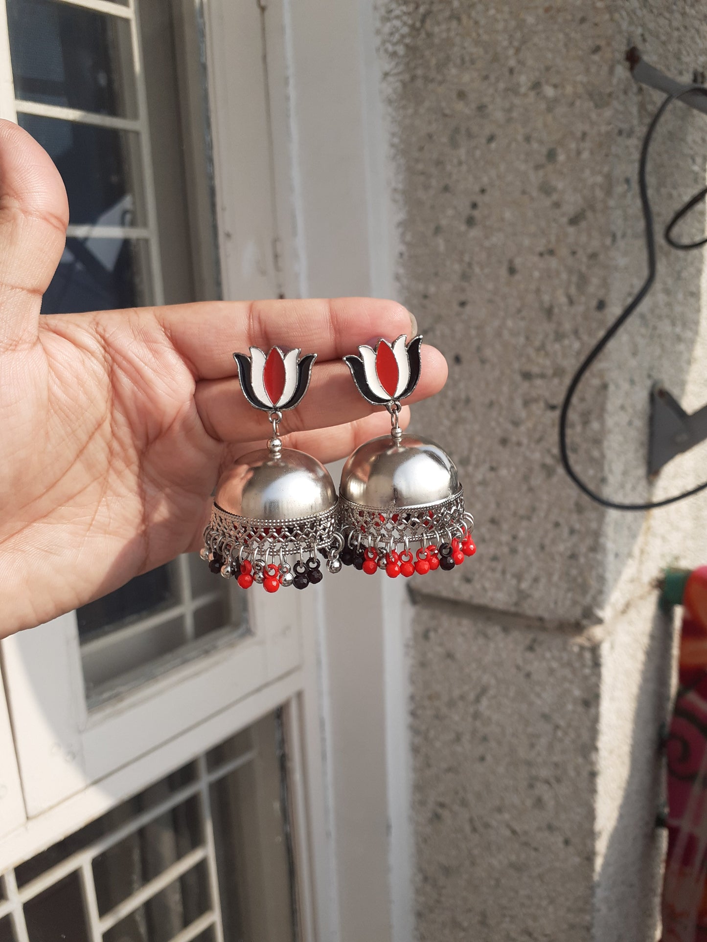 Shop red black lotus trishul earrings at Jewellery Lovers. Anti-tarnish, trendy & perfect for daily or festive wear. Free shipping available. jewellerylovers