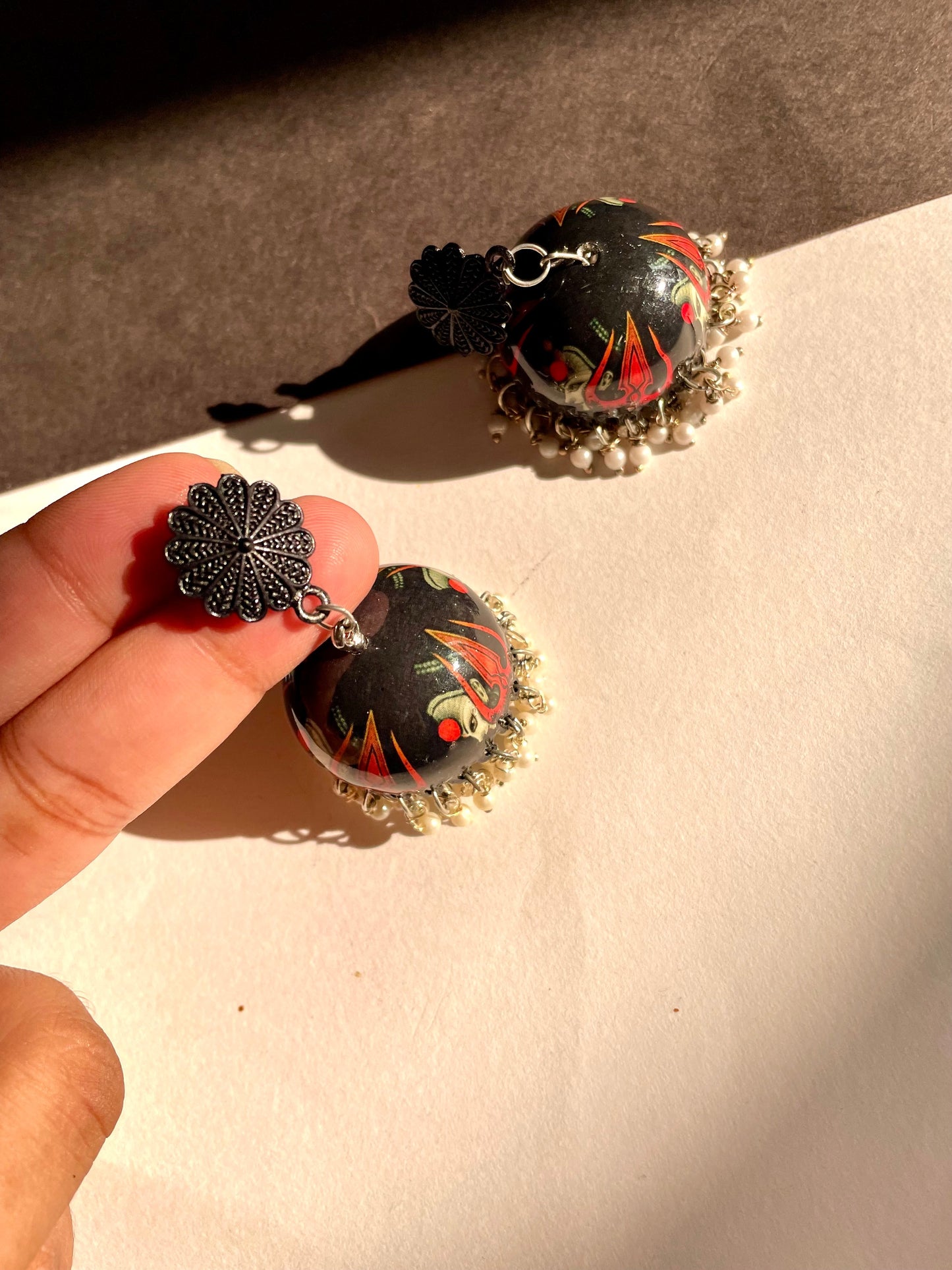 Shop trishul handpainted jhumka at Jewellery Lovers. Anti-tarnish, trendy & perfect for daily or festive wear. Free shipping available. jewellerylovers