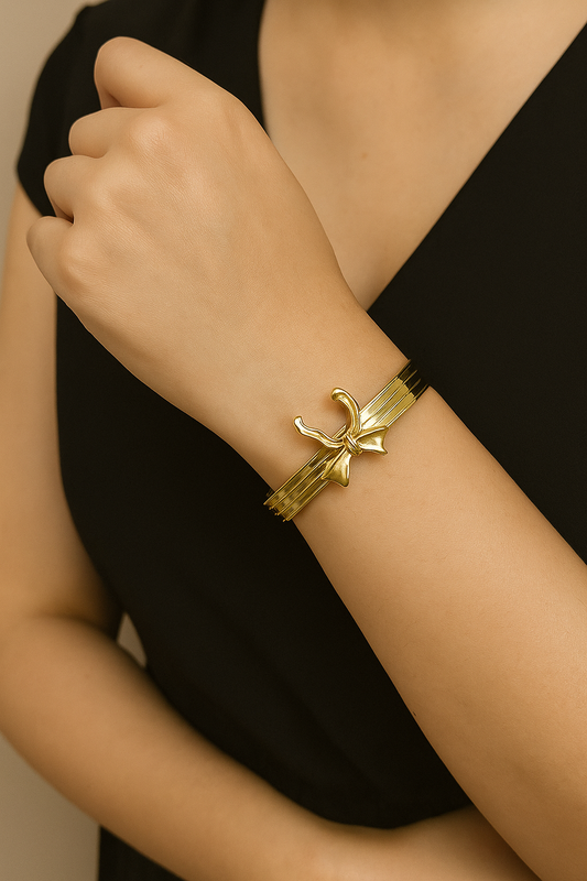 Shop golden bow charm cuff - elegant minimal bracelet at Jewellery Lovers. Anti-tarnish, trendy & perfect for daily or festive wear. Free shipping available. jewellerylovers