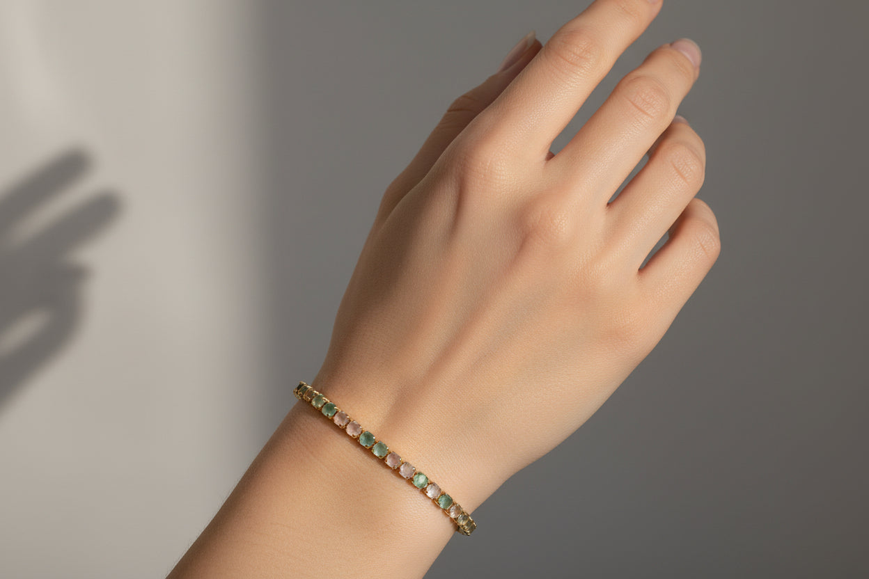 Bracelet with green gemstones on a white background
