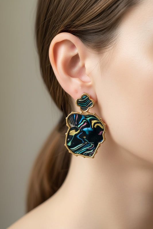 Pair of earrings on a jewelry card with a light background