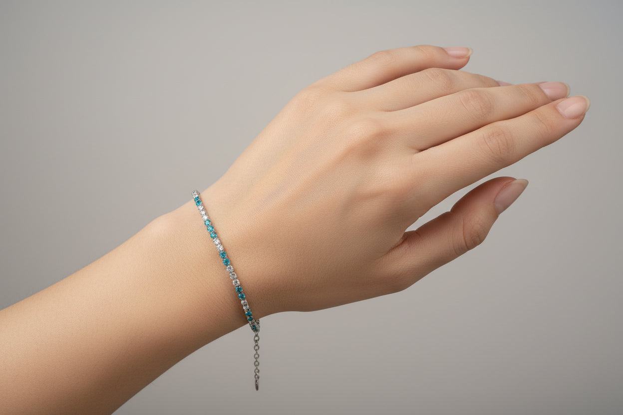 Silver bracelet with blue beads on a white background