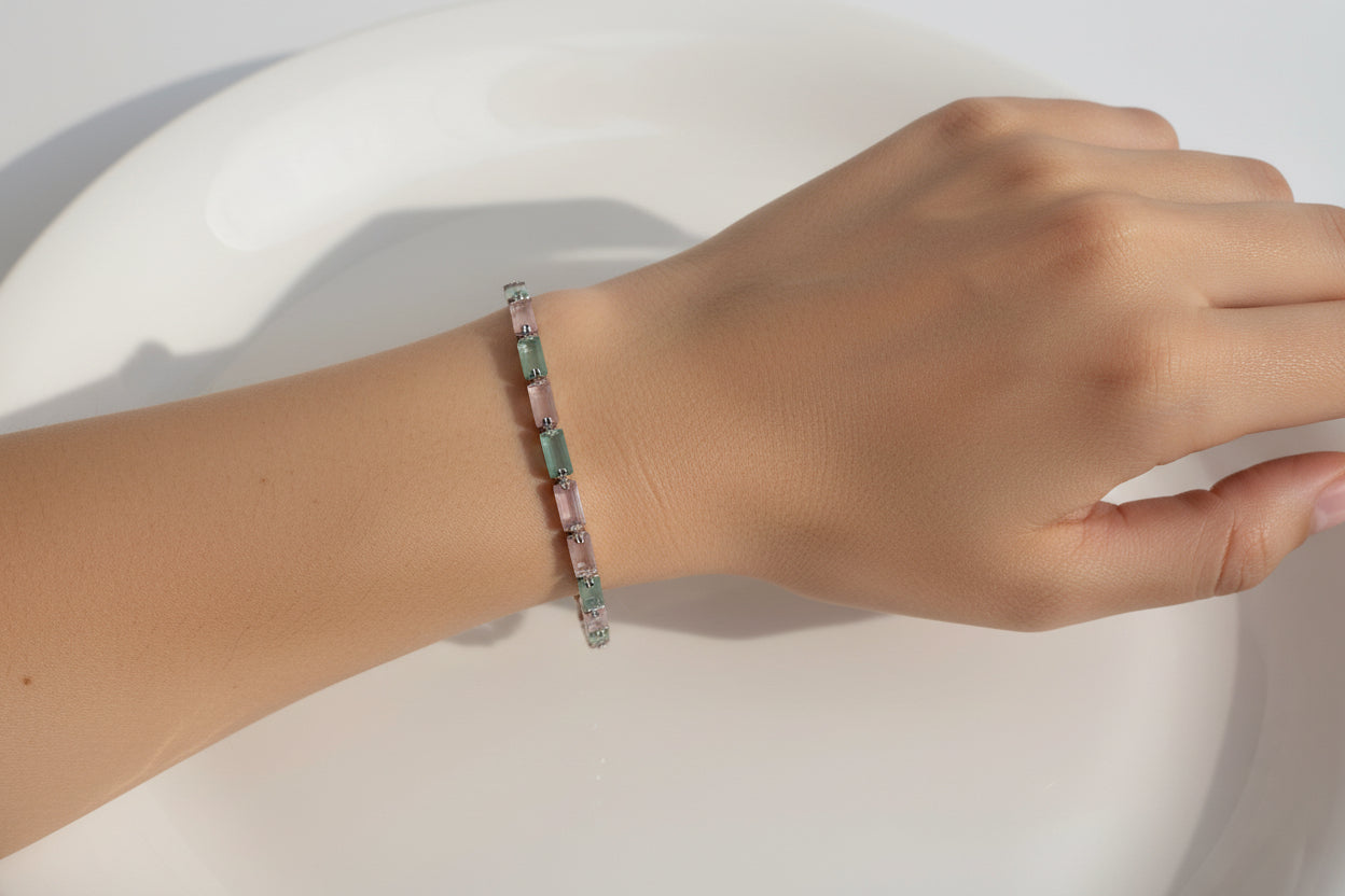 Bracelet with green and pink stones on a white background